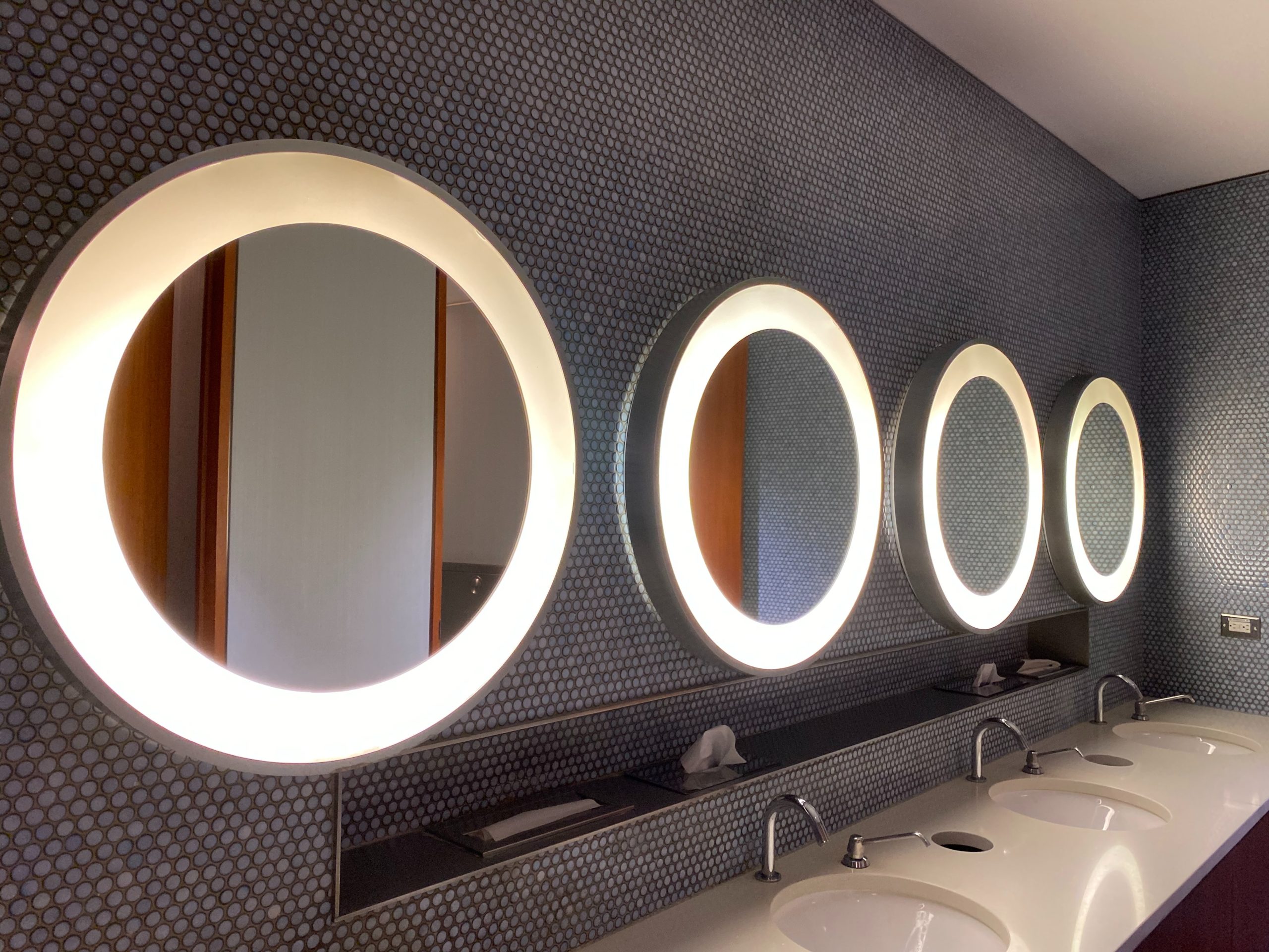 A clean and sophisticated bathroom with mirrors and sinks